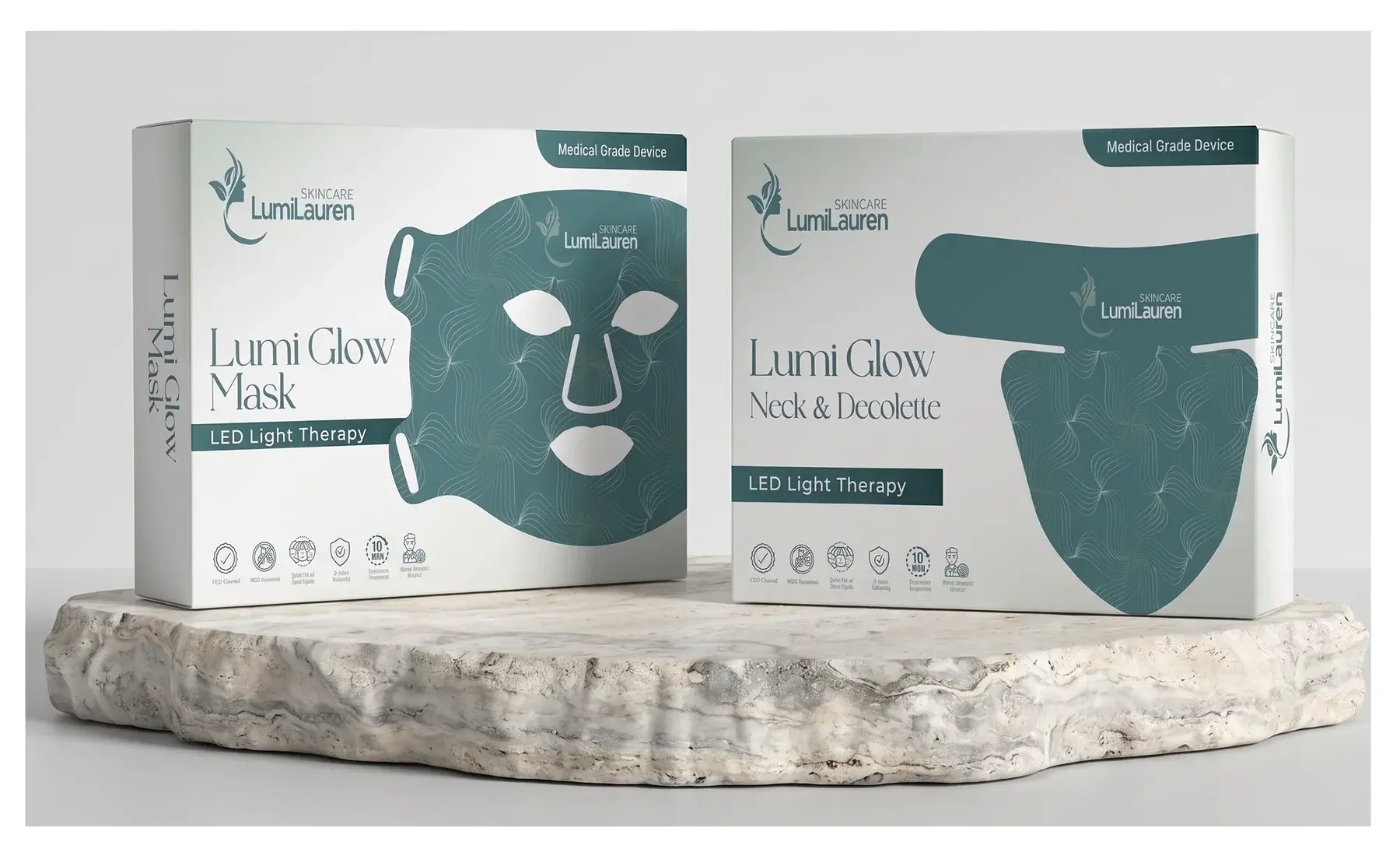 Lumi Glow Mask and Lumi Glow Neck and Décolleté LED light therapy boxes on a rock