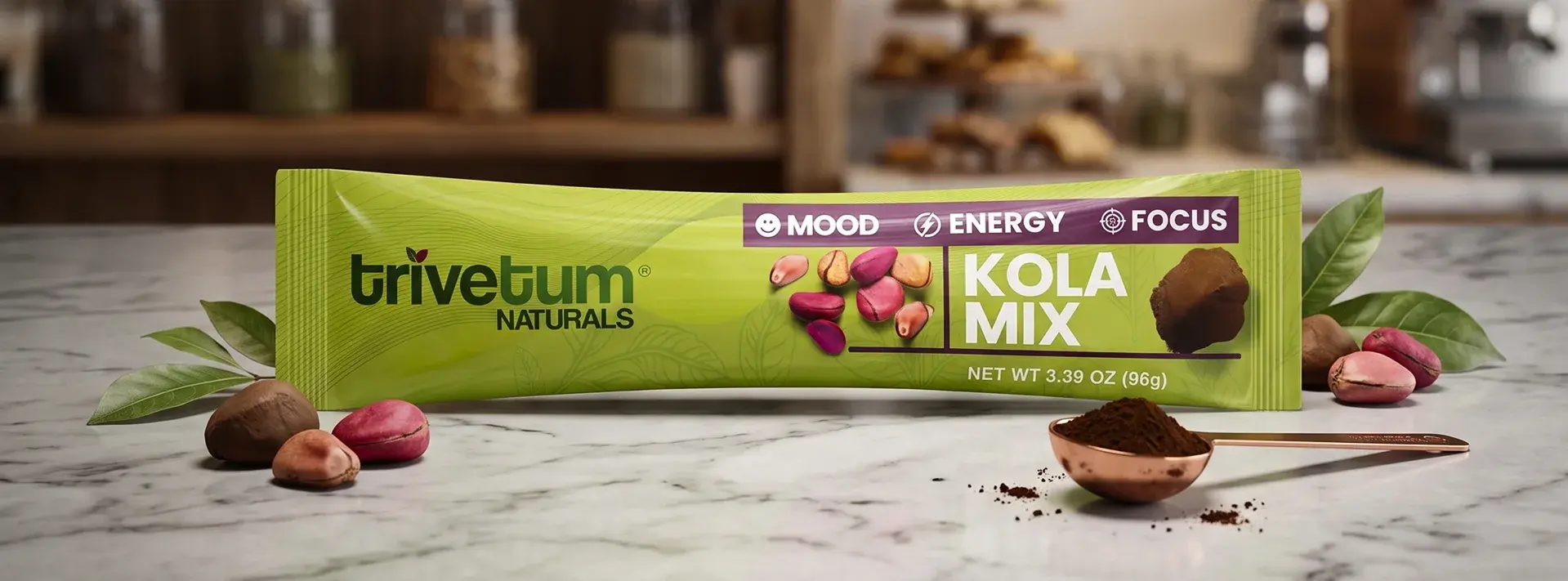 Kola Mix single-serve packet on marble with kola nuts and a spoon of powder