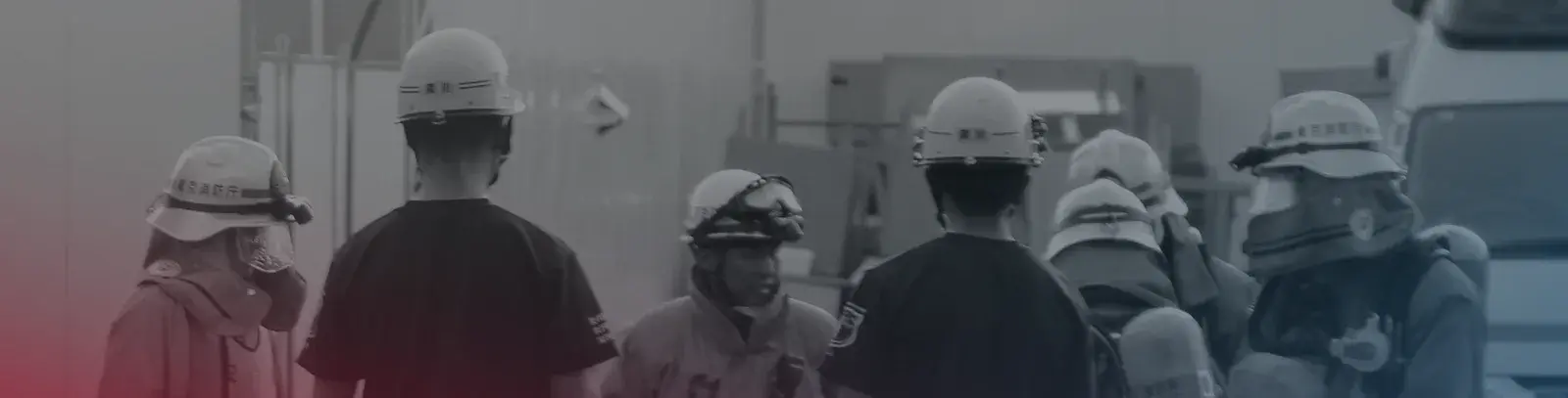 Photographic band of emergency service crews in hard hats used across the deck