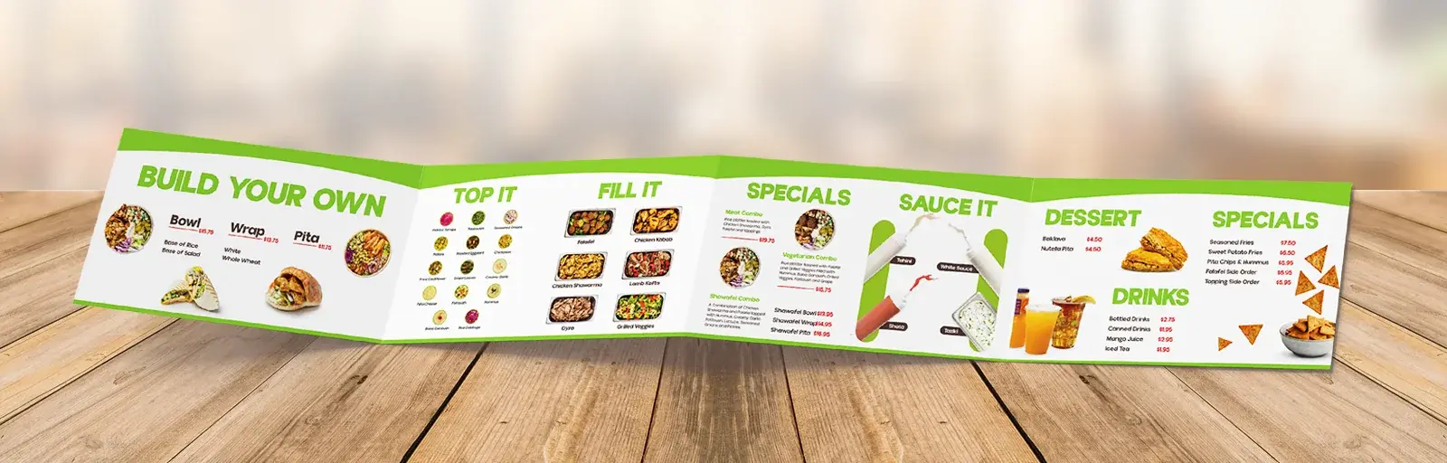 The printed four-panel fold-out menu standing open on a wooden table