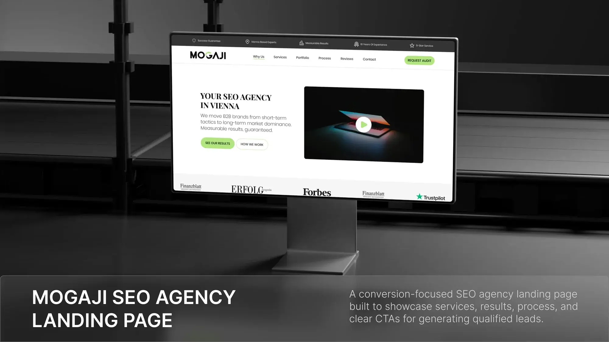 Mogaji SEO agency landing page shown on a desktop monitor in a dark studio setting